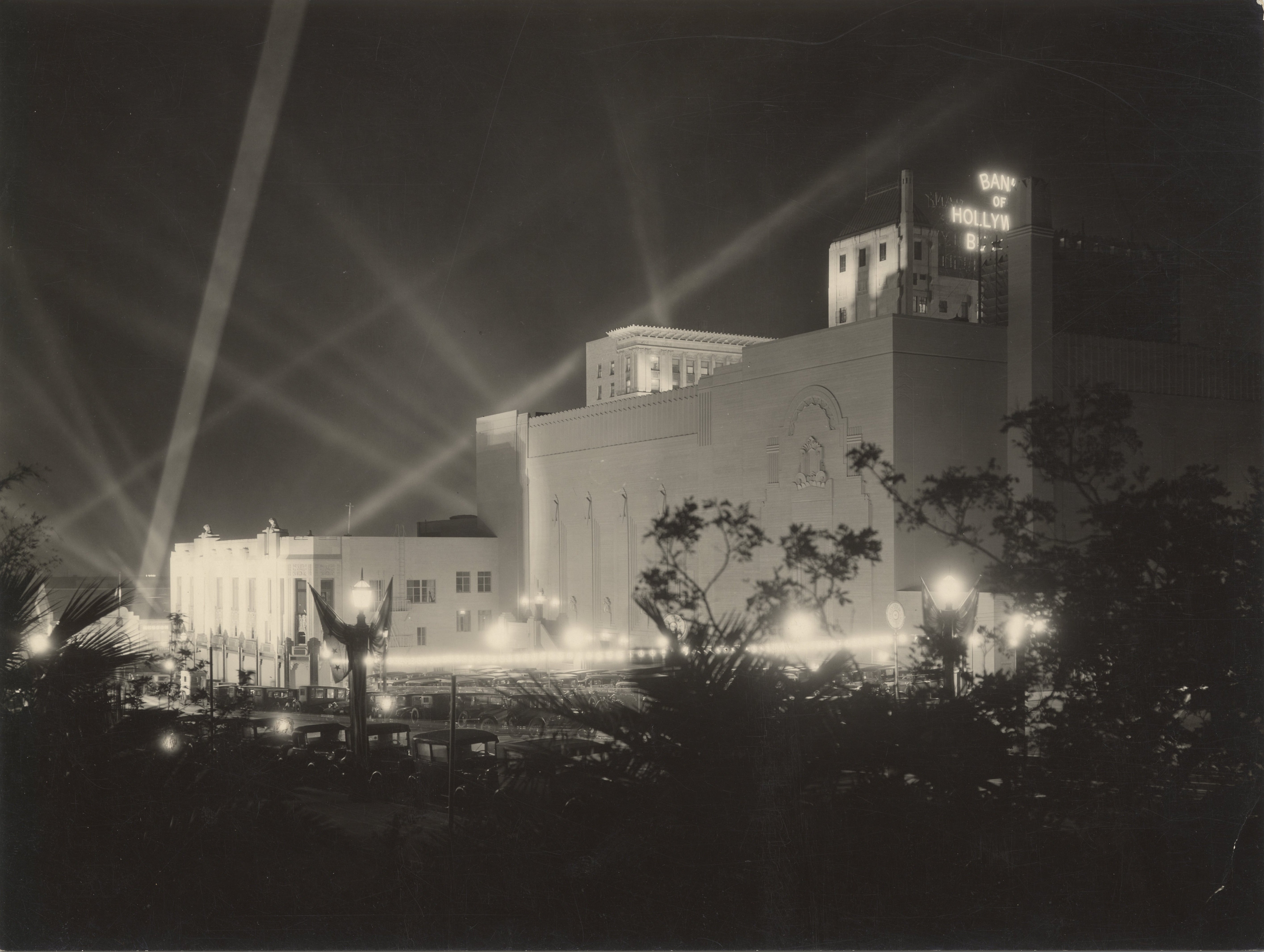 Pantages Theatre in Hollywood, California, illuminated by spotlights, view from the rear parking lot, 1923.